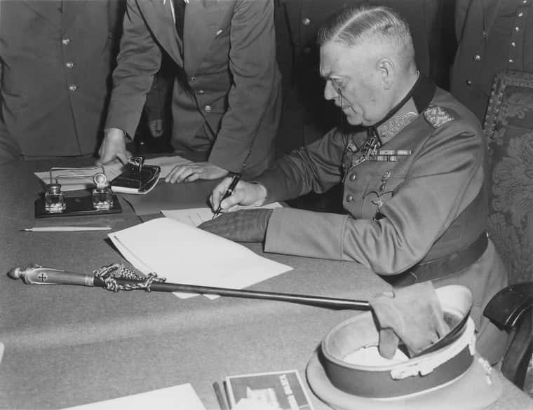 Field_Marshall_Keitel_signs_German_surrender_terms_in_Berlin_8_May_1945_-_Restoration.jpg