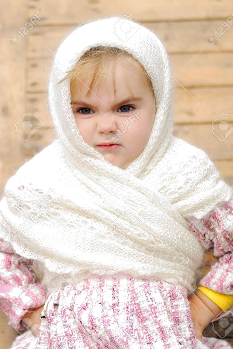 0_1478087579611_12361254-The-small-beautiful-angry-girl-in-a-white-scarf-at-a-fence-Stock-Photo.jpg